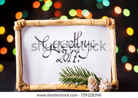 Goodbye 2017 card in a wooden frame with festive lights