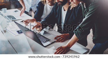 Working process at office.Group of young coworkers work together modern coworking studio.Young people making conversation with partners.Horizontal Wide.Blurred background Royalty-Free Stock Photo #739241962