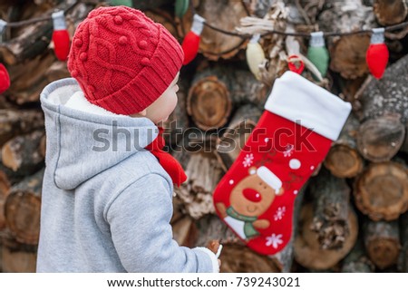New Year concept. boy with Christmas sock for gifts outdoor