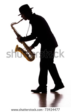 A photographic silhouette of a saxophone player into the moment Royalty-Free Stock Photo #73924477