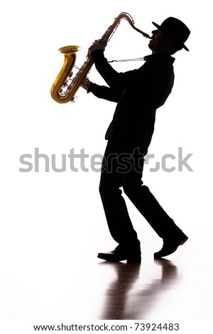 A photographic silhouette of a saxophone player into the moment Royalty-Free Stock Photo #73924483
