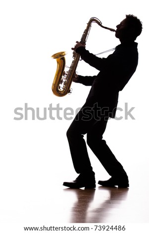 A photographic silhouette of a saxophone player into the moment Royalty-Free Stock Photo #73924486