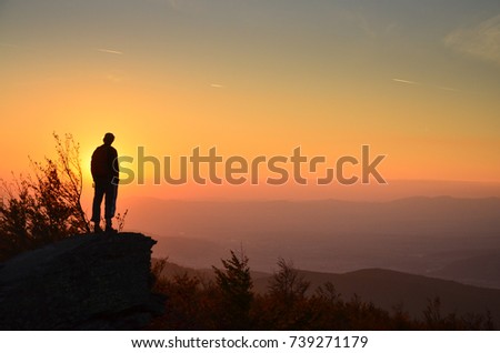 Tourist and sunset - colorful photo with copy space
