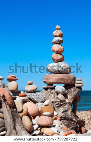 Stones balance on a background of blue sky and sea. Concept of balance and harmony. Rock zen