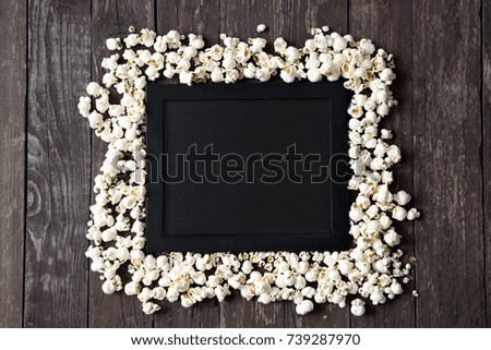 Movie clapper with fresh popcorn

