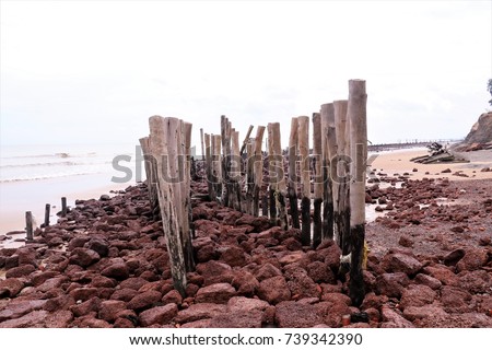 red sandstone and wooden line on the beach