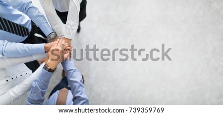 Close up top view of young business people putting their hands together. Stack of hands. Unity and teamwork concept. Royalty-Free Stock Photo #739359769