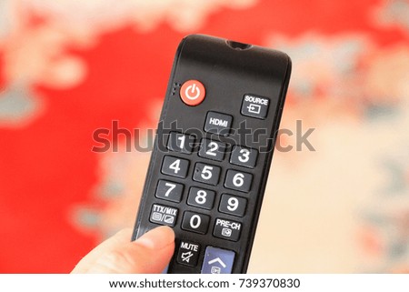 Remote control in woman's hand