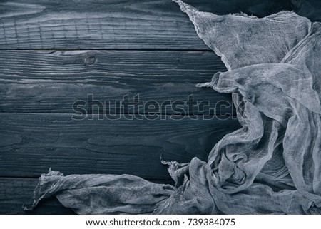 Lining fabric on a wooden background. Top view. Free space for your text.