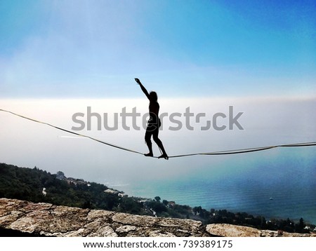 Rope Walker with a Wonderful view of Trieste 's landscape in Italy where the sea meets the mountains in a unique way. Royalty-Free Stock Photo #739389175