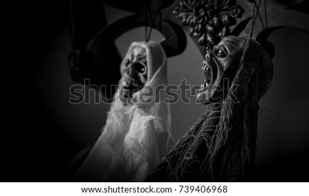 Halloween decoration of couple skeleton sitting on the chairs in black and white, Halloween decoration background concept 