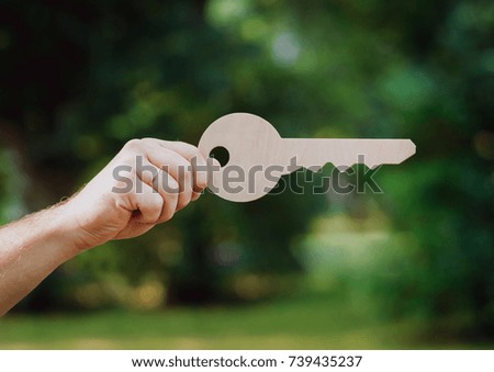 The key of the house is in man hands. Advertising signs