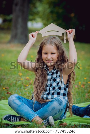 Young girl with advertising signs in the park. Summertime