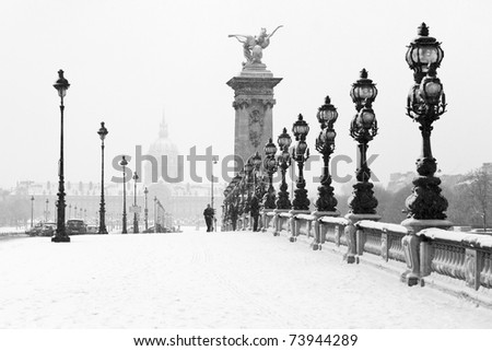 The Alexandre III bridge of Paris under the snow with the Invalides in the background