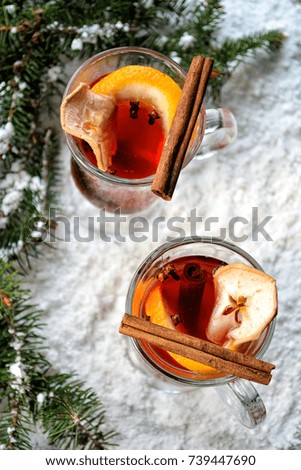 Two glasses of mulled wine in a snow near