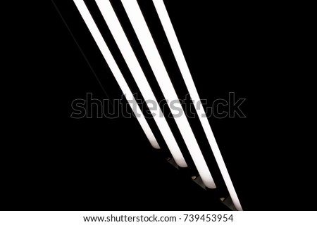 LED fluorescent light tubes on black background. Professional lighting equipment for photo or video production.