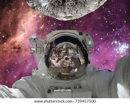 Astronaut and alieb planet (moon) on the backdrop. The elements of this image furnished by NASA.