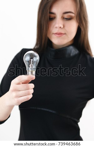 young girl holding a light bulb in her hands, concept ideas, a lump over her head