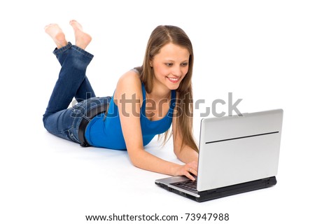 Young woman lying on floor using laptop