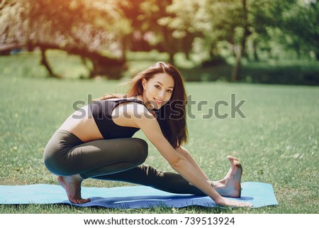 Beautiful and slender girl doing yoga in nature