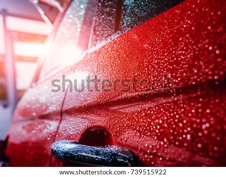 Details of electric car. Door handle and rain drops. Red color Royalty-Free Stock Photo #739515922