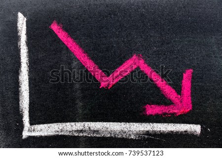 Red color hand drawing chalk in arrow down shape on black board background (Concept of stock decline, down trend of business, economy)