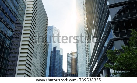 Common modern business skyscrapers, high-rise buildings, architecture raising to the sky, sun. Concepts of financial, economics, future etc.