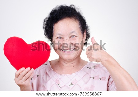 Senior woman holding heart