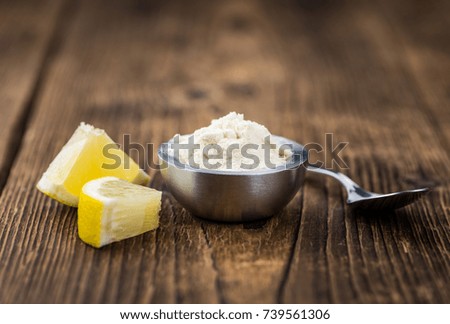 Wooden table with Lemon powder (detailed close-up shot; selective focus)