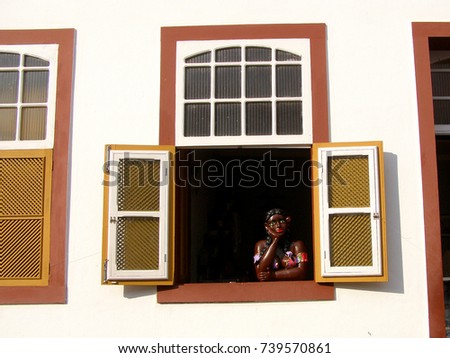 Traditional brazilian souvenir girl at the country house window in Ouro Preto Minas Gerais Brazil