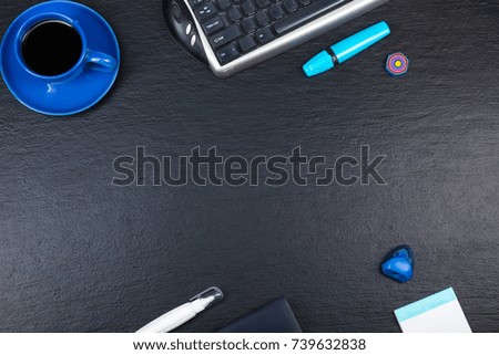 Black Office desk table with computer, pen and a cup of coffee, lot of things. Top view with copy space