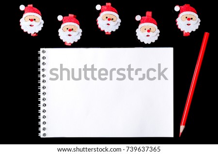 Letter santa: notebook and pencil on a Christmas background, top view. New Year decor with copy space.