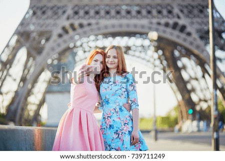 Two friends taking selfie near the Eiffel tower in Paris, France
