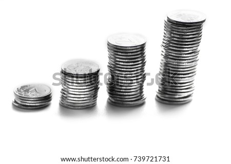 Columns of silver coins isolated on white.