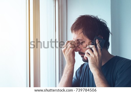 Unpleasant phone call, worried anxious man talking with someone on mobile phone Royalty-Free Stock Photo #739784506
