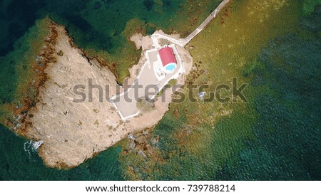 Aerial bird's eye view photo taken by drone of small chapel built in a rock of Agios Isidoros, Leros island, Dodecanese, Greece