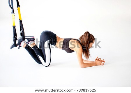 A young girl trains in a gym. Demonstration of fitness exercises for fly yoga gym