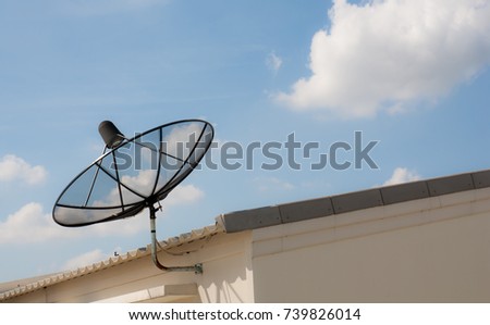 Satellite on roof with blue sky background