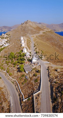Aerial bird's eye view photo taken by drone of beautiful windmills with view to fortified castle of Panteli, Dodecanese, Greece