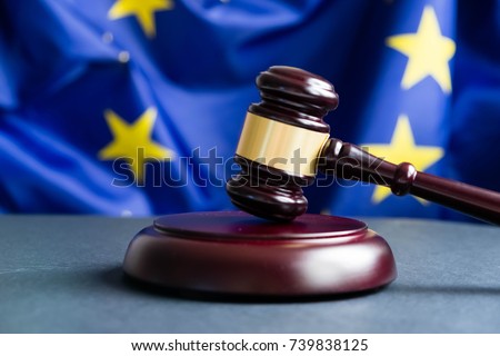 Judges wooden gavel with EU flag in the background. Symbol for jurisdiction. Wooden gavel on european union flag Royalty-Free Stock Photo #739838125