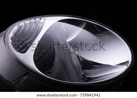close-up round car headlights on a black background isolated