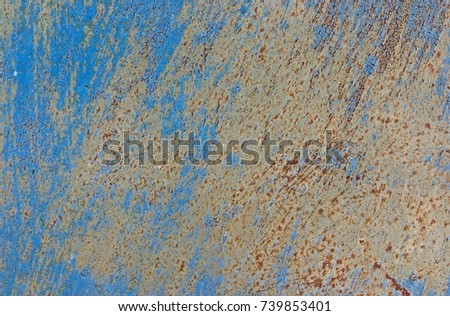 Red rust on metal. Abstract blank background of an iron panel with a blue spoiled peeling paint, traces of corrosion, scratches, weather and age damage.