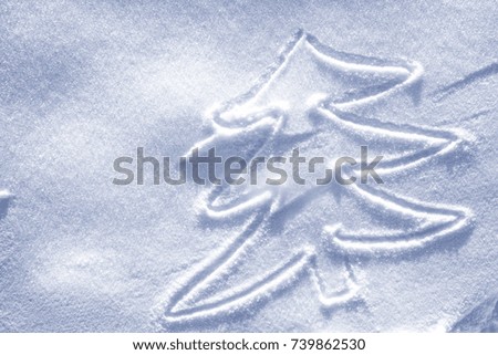 Hand christmas tree drawing on snow 