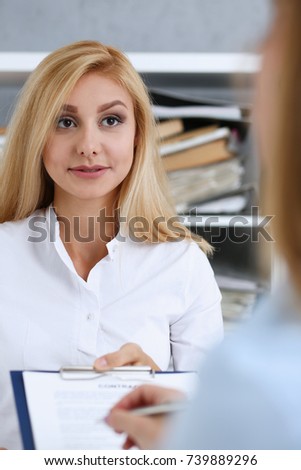 Female arm in white shirt offer contract form