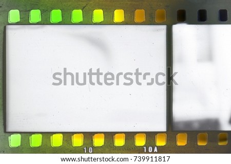 Vintage film strip frame with green and yellow tones.