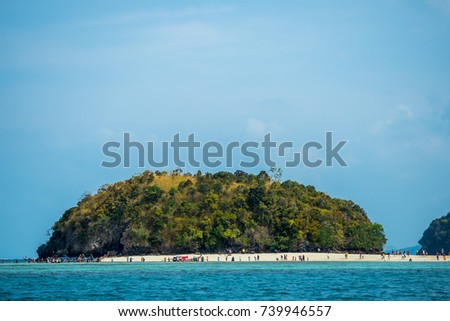 riding wood boat to tup island in thailand. green island and peaceful ocean and clear blue sky in a beautiful summer day. blue ocean and sky background. 