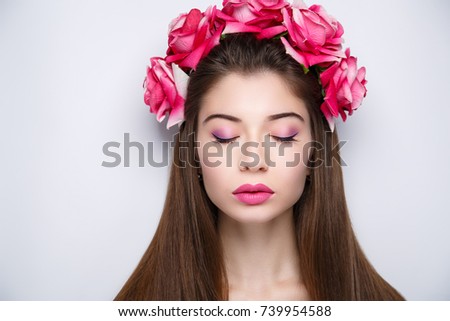 Beautiful woman wearing massive flower wreath. Long black straight hair. Professional cosmetics makeup. Natural lipstick lip-gloss. New photo close up portrait, gray color background horizontal banner