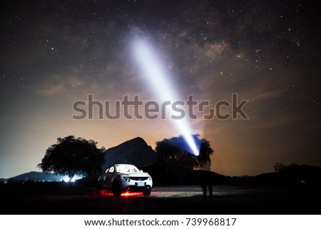 Night sky of milky way with car and camping tent in front of mountain background location at Kanchanaburi , Thailand 