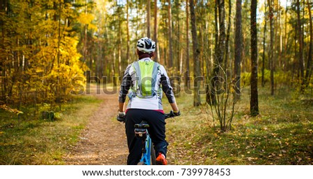 Image from back of girl in helmet on bicycle