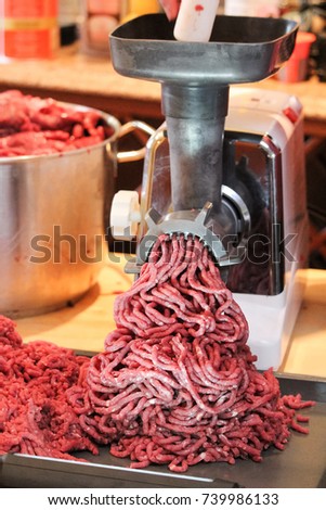 Processing and grinding moose meat at home.